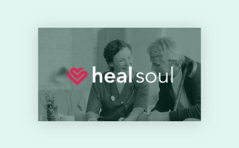 A healthcare professional smiles and talks with an older man; over the image is a pink heart icon and the text healsoul.