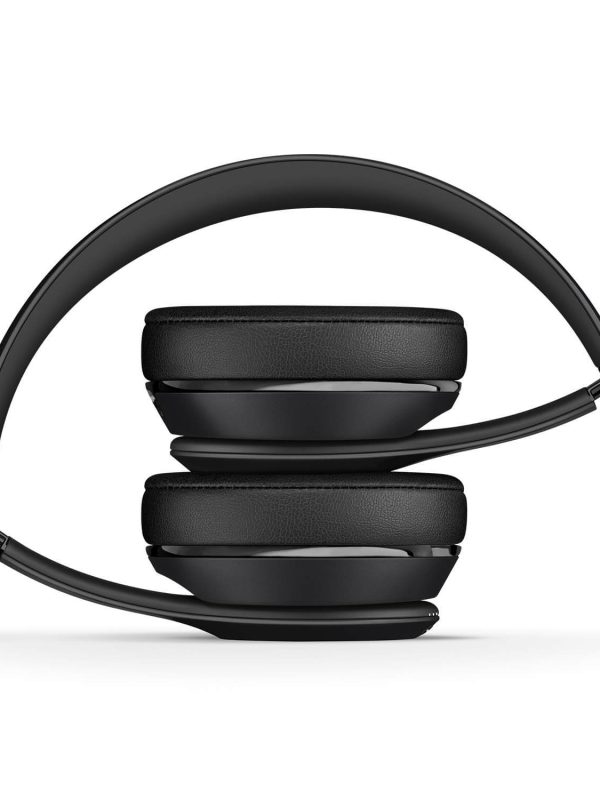 A pair of black over-ear headphones folded compactly with the ear cups pressed together and the headband curved around them, shown against a white background.