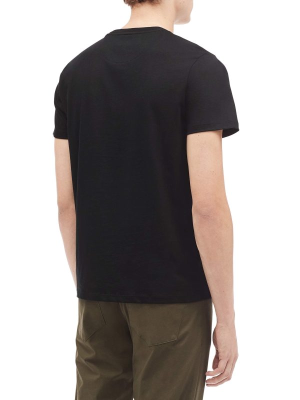 A person wearing a plain black short-sleeve t-shirt and olive-green pants is shown from the back against a white background.