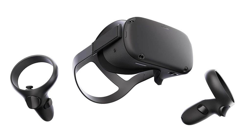 A black virtual reality headset with two matching wireless controllers shown on a white background. The headset has a head strap and the controllers each have buttons and a joystick.