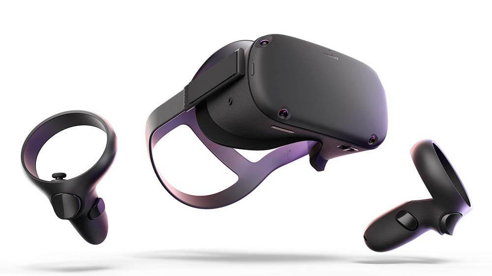 A black virtual reality headset with two matching handheld controllers is shown against a white background. The headset and controllers appear to be floating in mid-air.