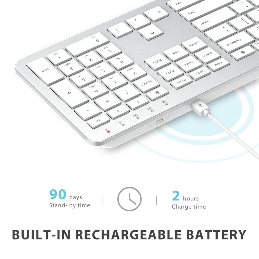 A slim, silver wireless keyboard connected to a white charging cable. Text reads: 90 days stand-by time, 2 hours charge time. Built-in rechargeable battery.