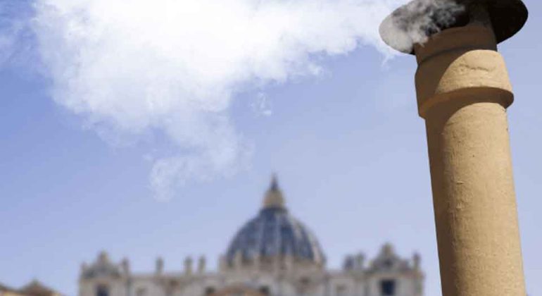 A plume of white smoke rises from a chimney in front of St. Peter’s Basilica at the Vatican, signaling the election of a new pope.