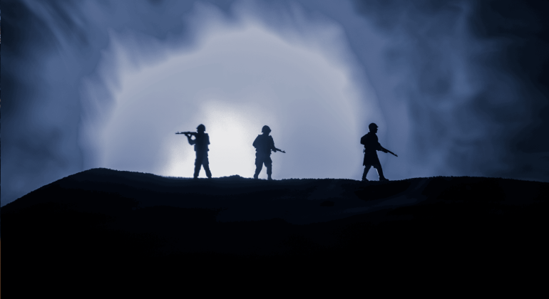 Three armed soldiers are silhouetted against a bright, smoky blue light, standing on a hill in the Magaliesberg, with a dramatic, cloudy sky behind them.