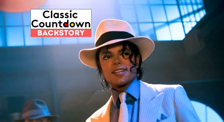 A person in a white fedora, pinstripe suit, and tie stands under dramatic lighting with princely flair. The text Classic Countdown Backstory appears in the upper left corner.