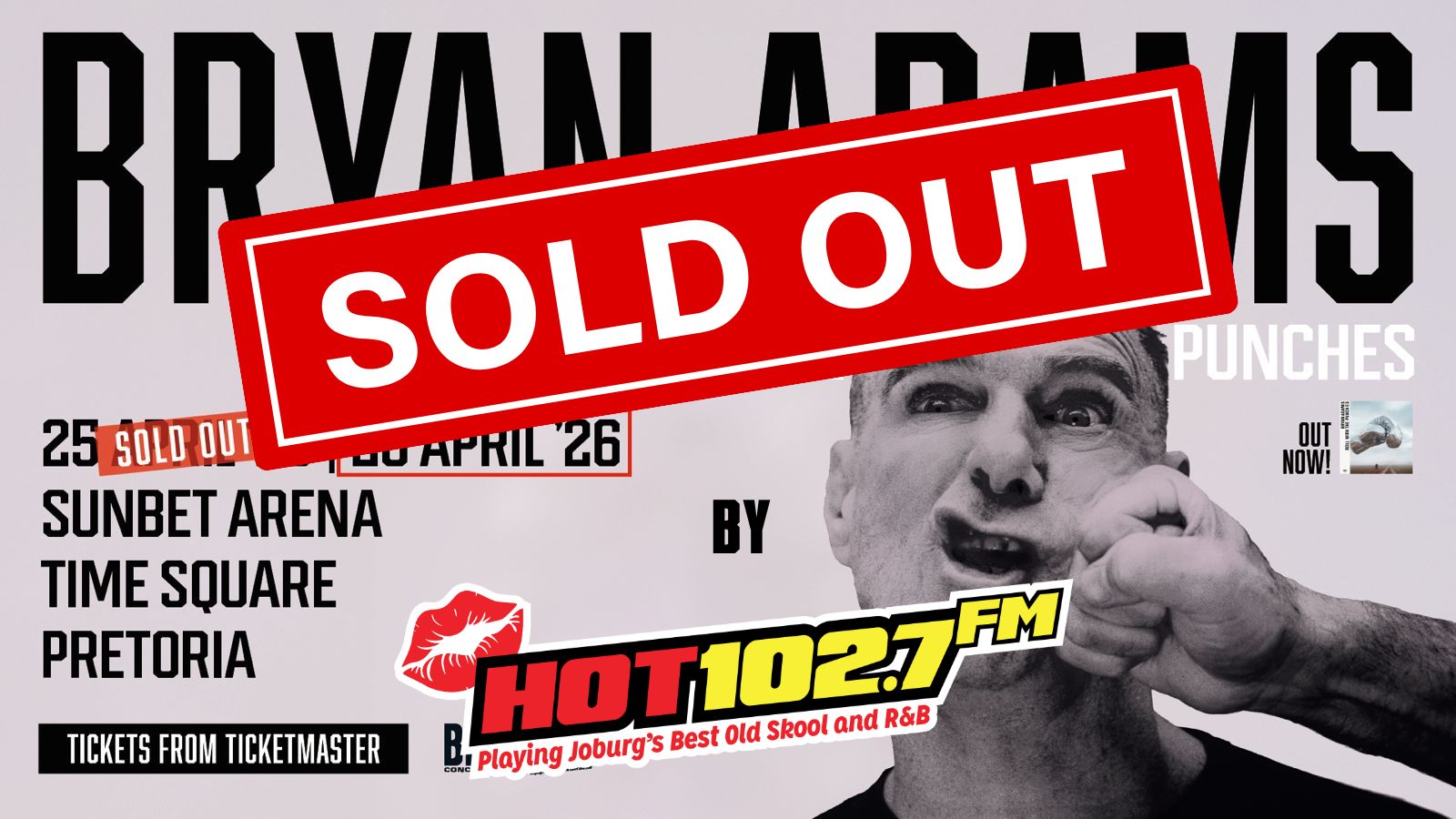 Concert poster for Bryan Adams at Sunbet Arena, Pretoria, shows a man being playfully punched with SOLD OUT in bold red across the image. Hot 102.7 FM logo and event details are visible.