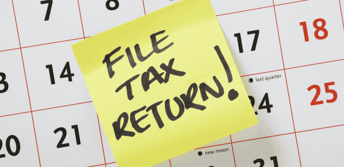 A yellow sticky note with FILE TAX RETURN! written in bold black letters is placed on a calendar, serving as an important reminder for Matric students to stay organized and meet their deadlines.