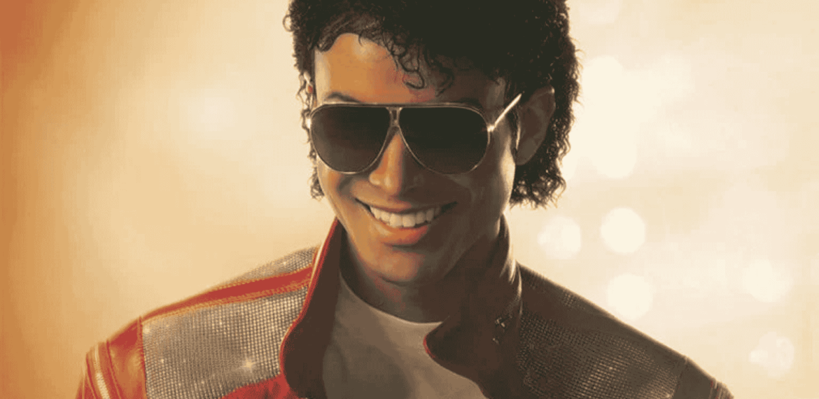 A person with curly hair wearing sunglasses, a red and silver jacket, and a white shirt smiles against a golden, softly lit background, evoking the vibrant style of Miriam Makeba.